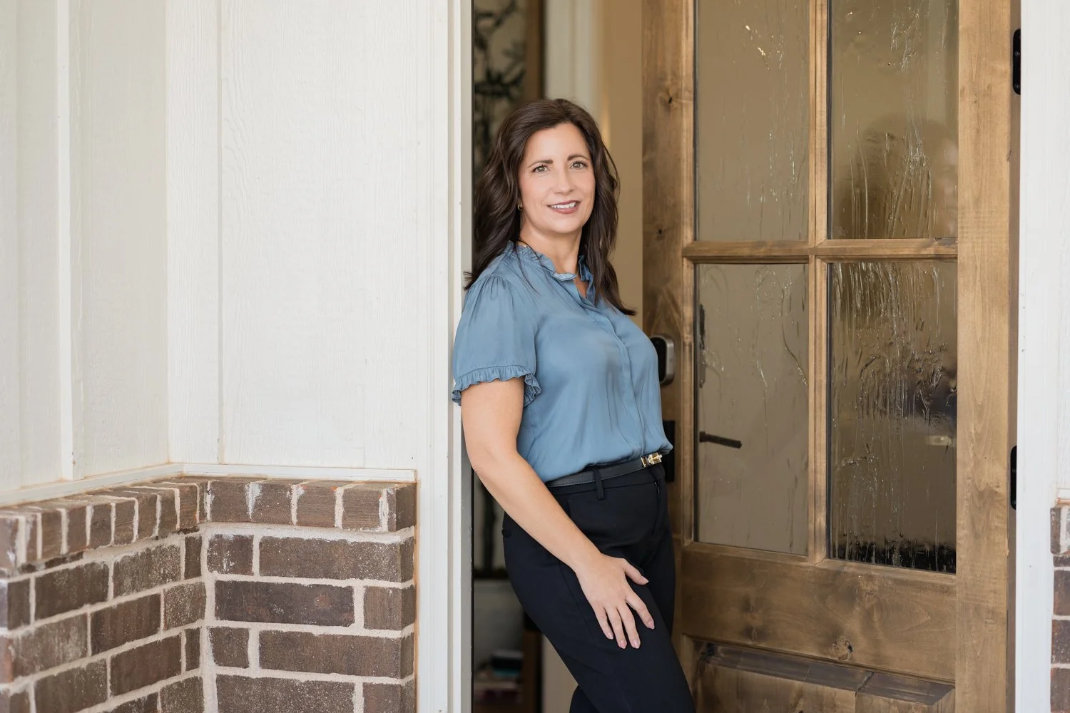 Edmond OK brand photographer capturing business owner in model home office