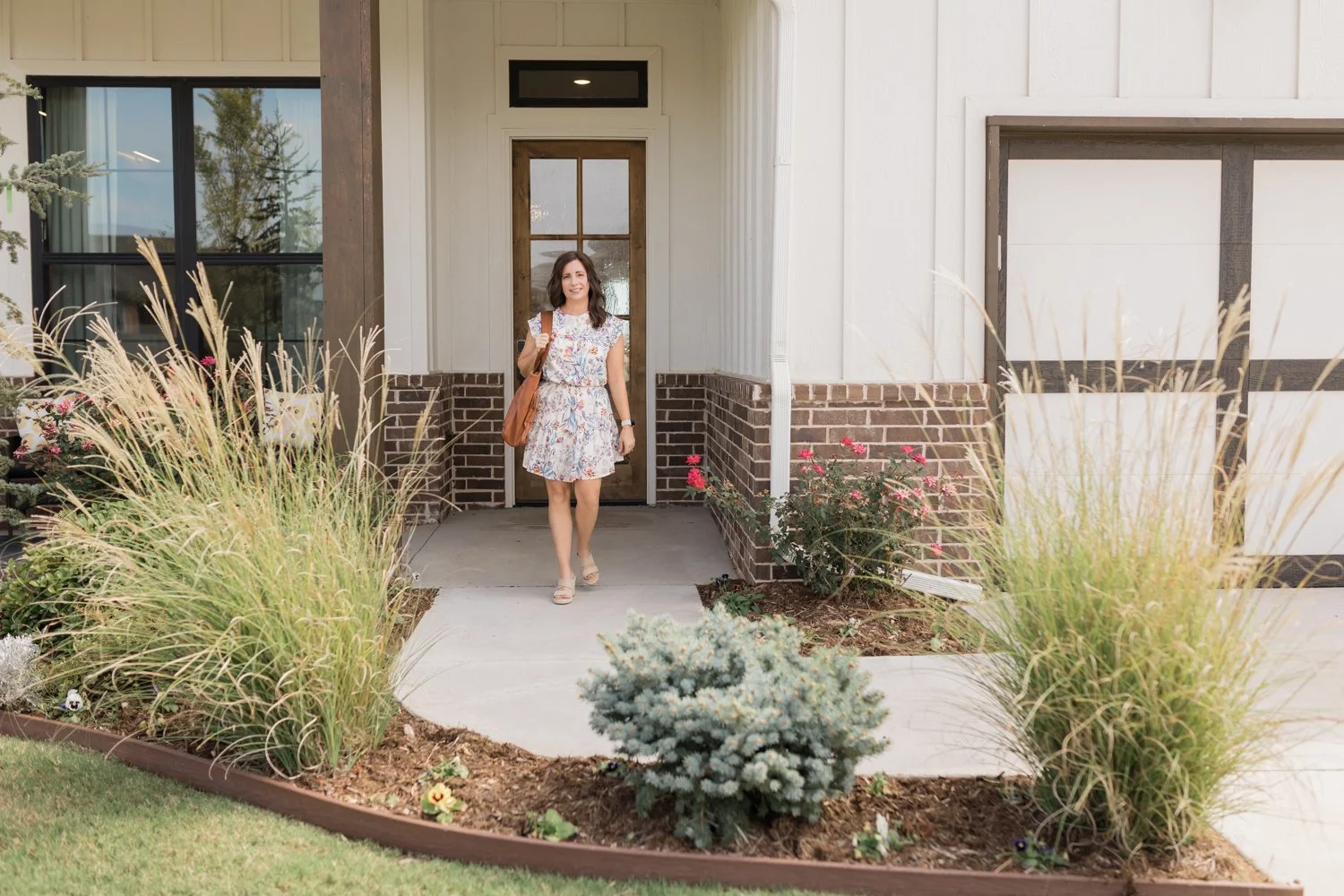 OKC headshot photographer capturing business professional outside model home”