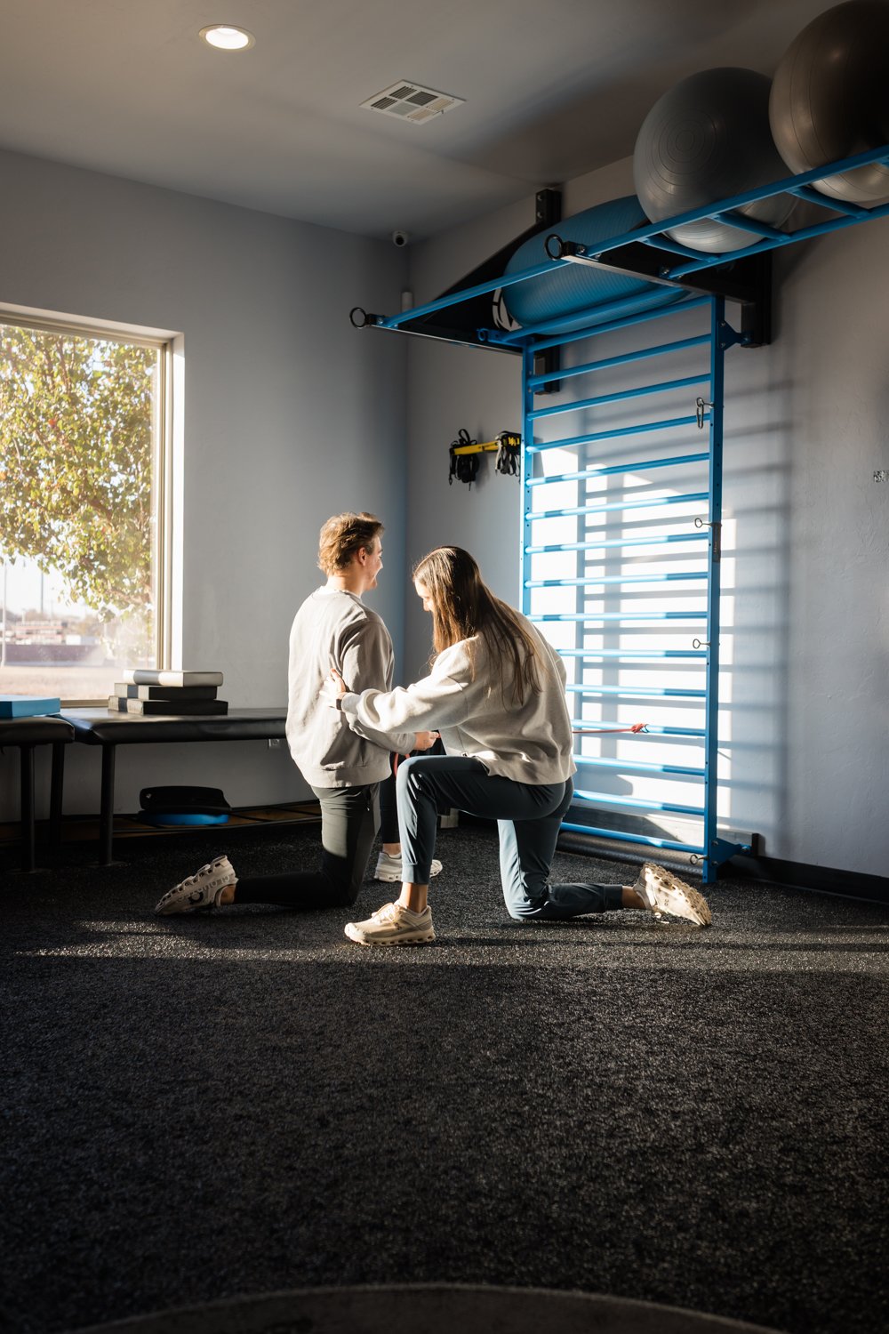 Physical therapist assisting athlete with recovery exercises in OKC