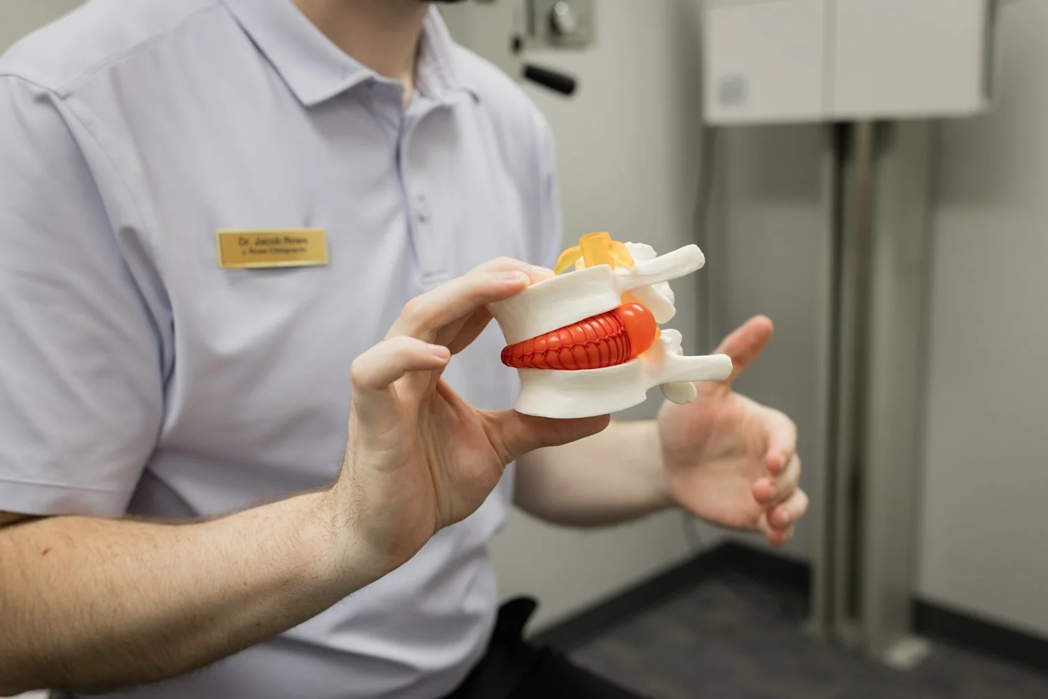 Chiropractor explaining treatment plan to patient in a relaxed setting