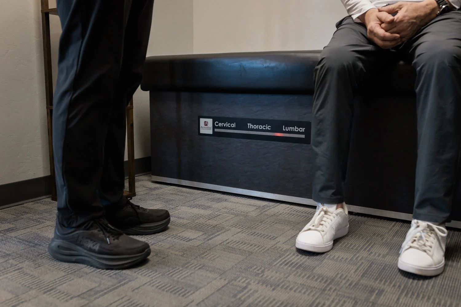 Brand session image of physical therapist working with client on rehab table