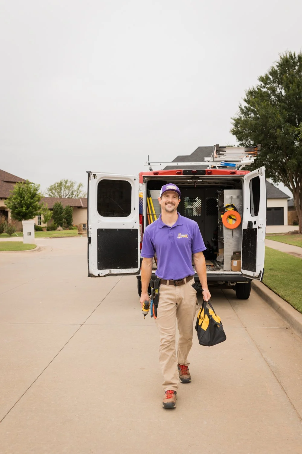 Electrician stepping out of service vehicle brand photography Oklahoma