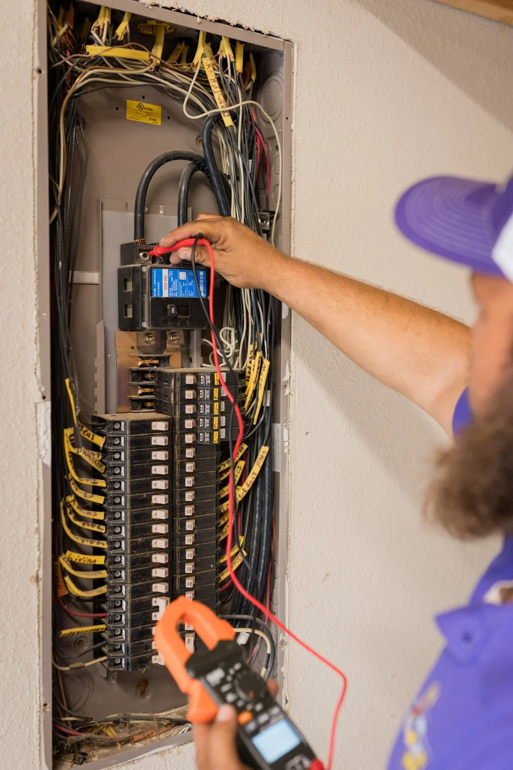 Electrician explaining electrical panel to homeowner Norman, Oklahoma brand shoot