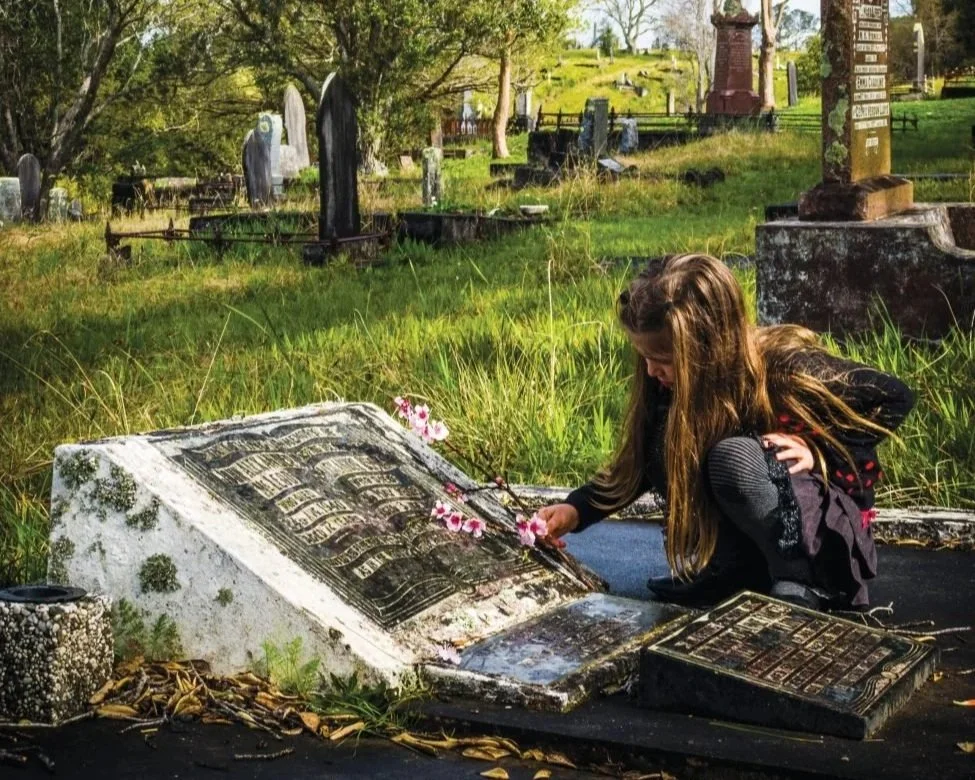 placing flowers on grave