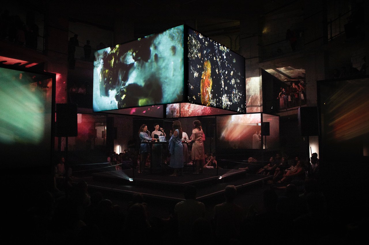 immersive art installation with screens and people