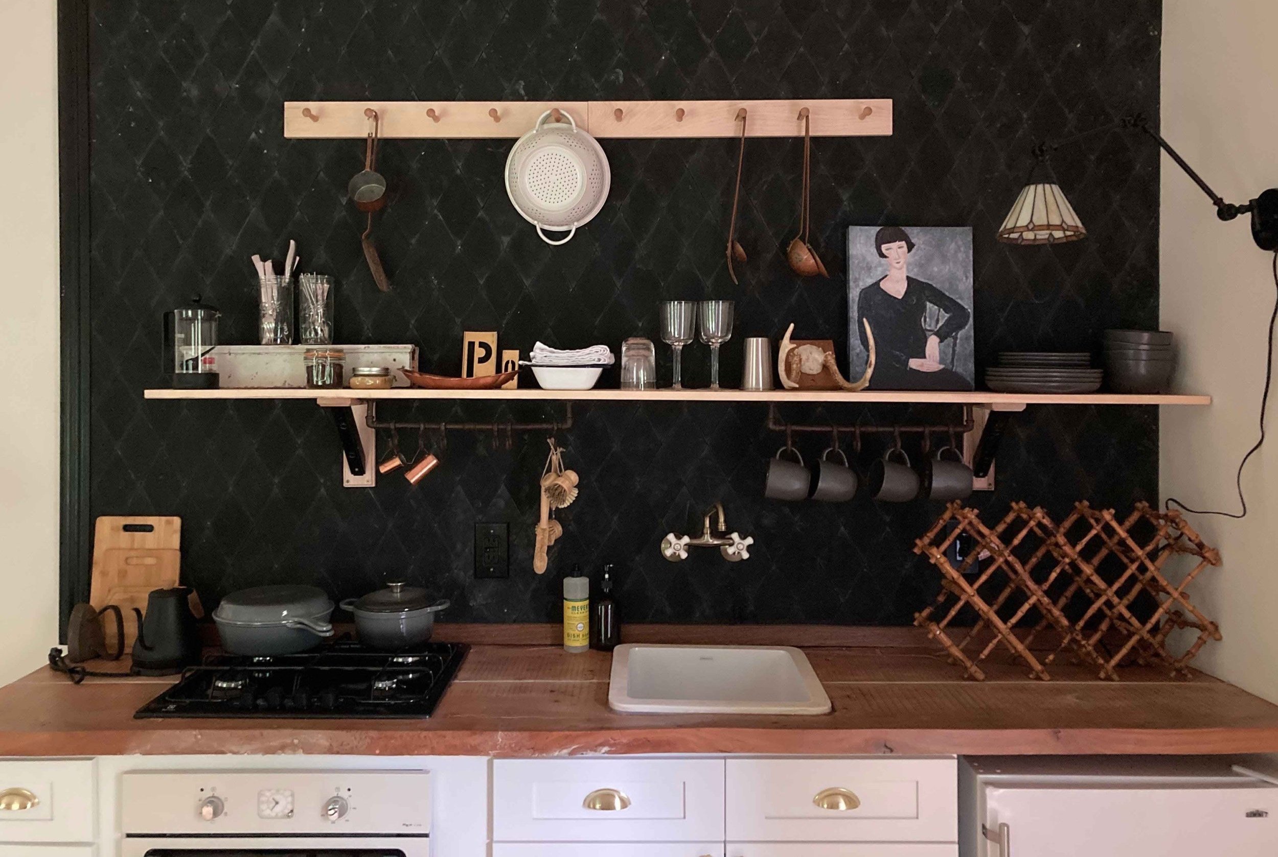 kitchen-at-the-studio-features-black-tile-and-cooking-tools.jpg