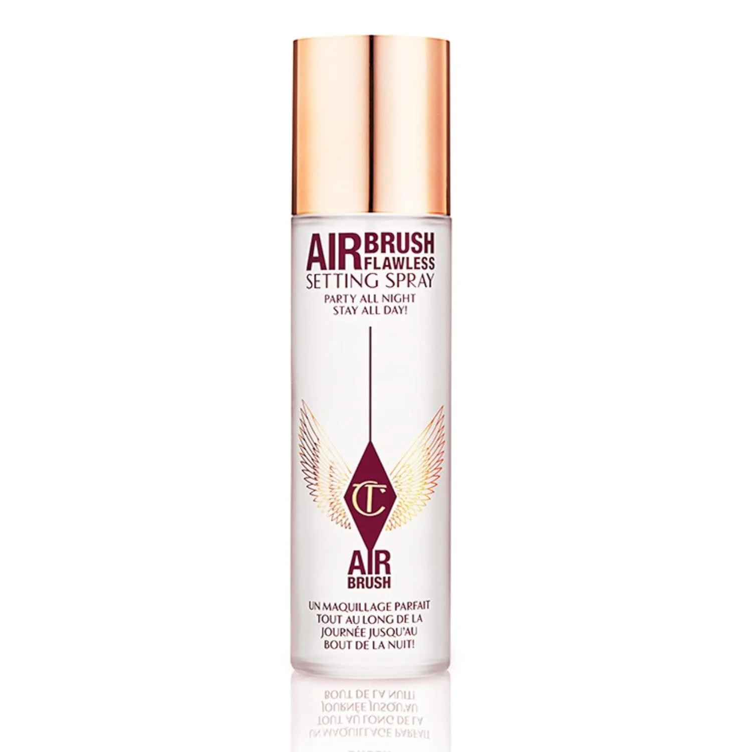 A tall, white, cylindrical spray bottle with a gold cap, labeled as 'Air Brush Flawless Setting Spray' from Charlotte Tilbury. The bottle features a winged logo and additional text in French, describing the product as a perfect makeup setting spray f