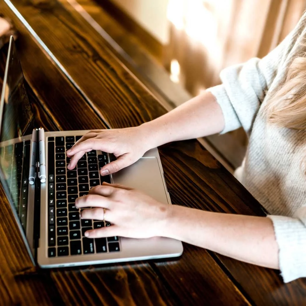 creating social media graphics on laptop