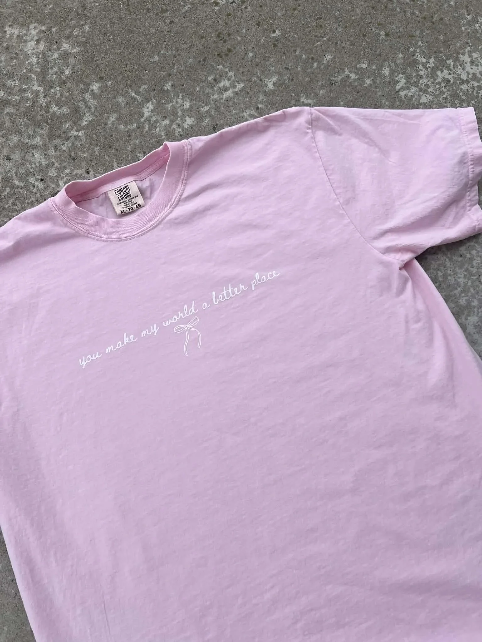 Pink tee with white text reading 'you make my world a better place"