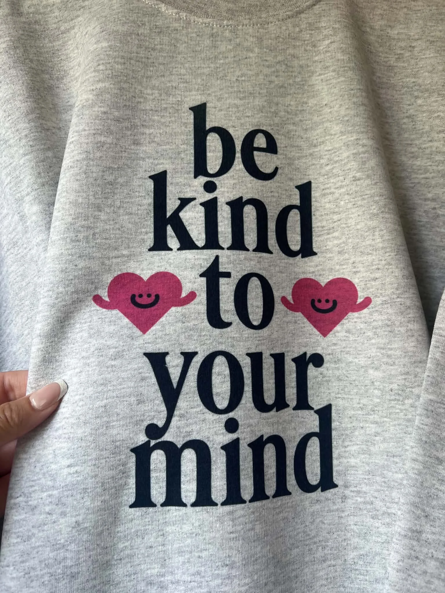 gray sweatshirt with be kind to your mind printed on it