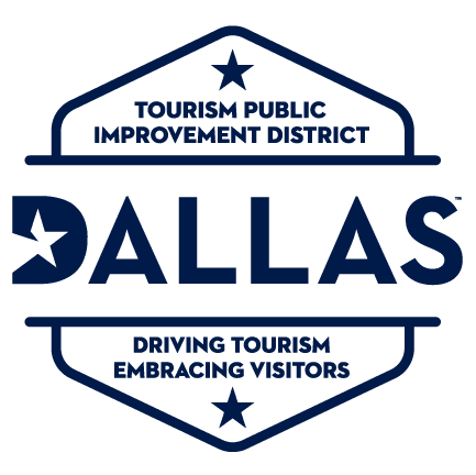 Dallas Tourism public improvement district sign with the text 'Driving tourism. Embracing visitors. Dallas'.