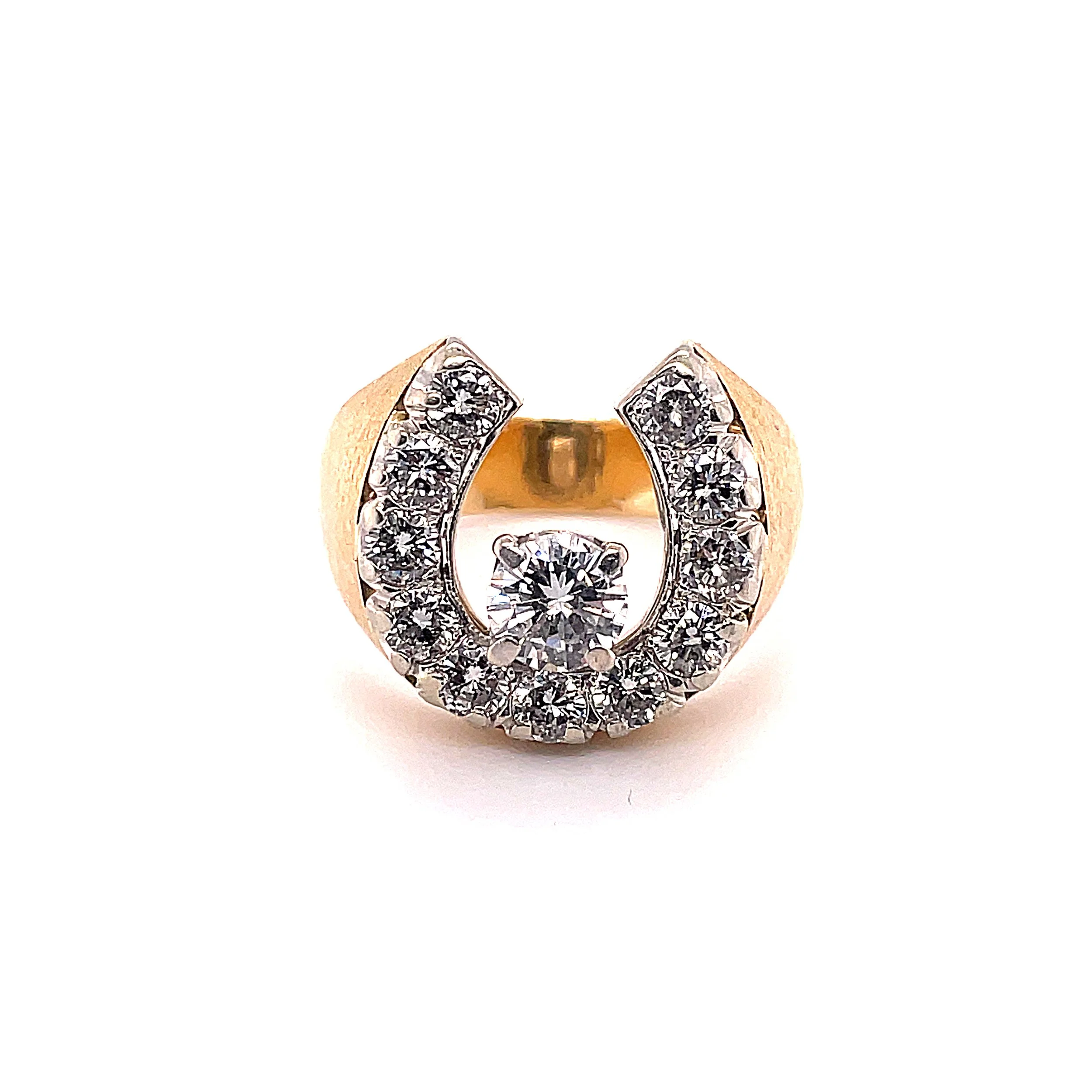 A gold ring with diamond embellishments on top, featuring a central round-cut diamond surrounded by smaller diamonds in a circular design.