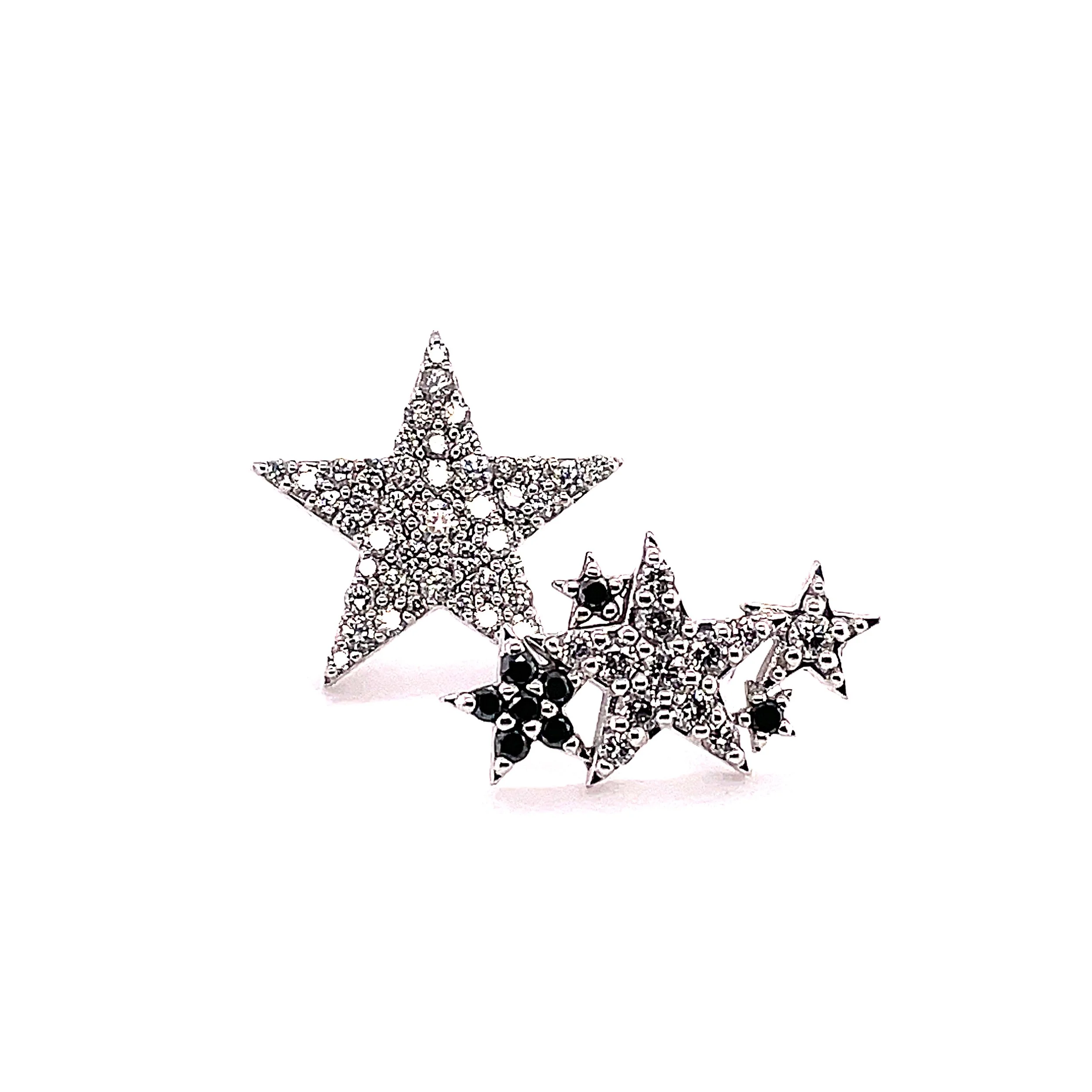 Decorative stars made of small beads and rhinestones arranged on a white surface.