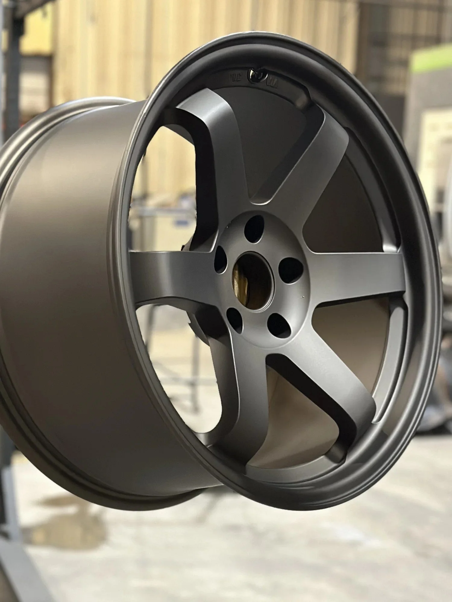 Satin finish five-spoke wheel powder coated at ADK Blast N Coat in Queensbury NY