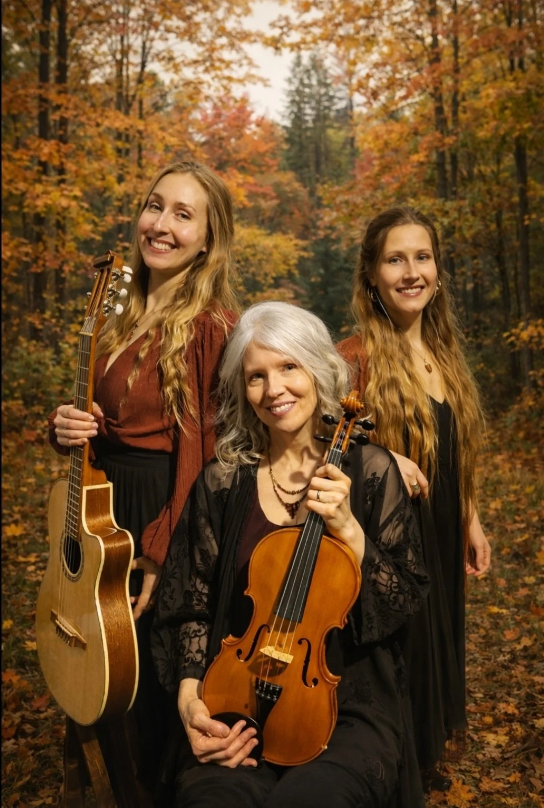 The Mystikana Trio pose smiling in an autumn forest