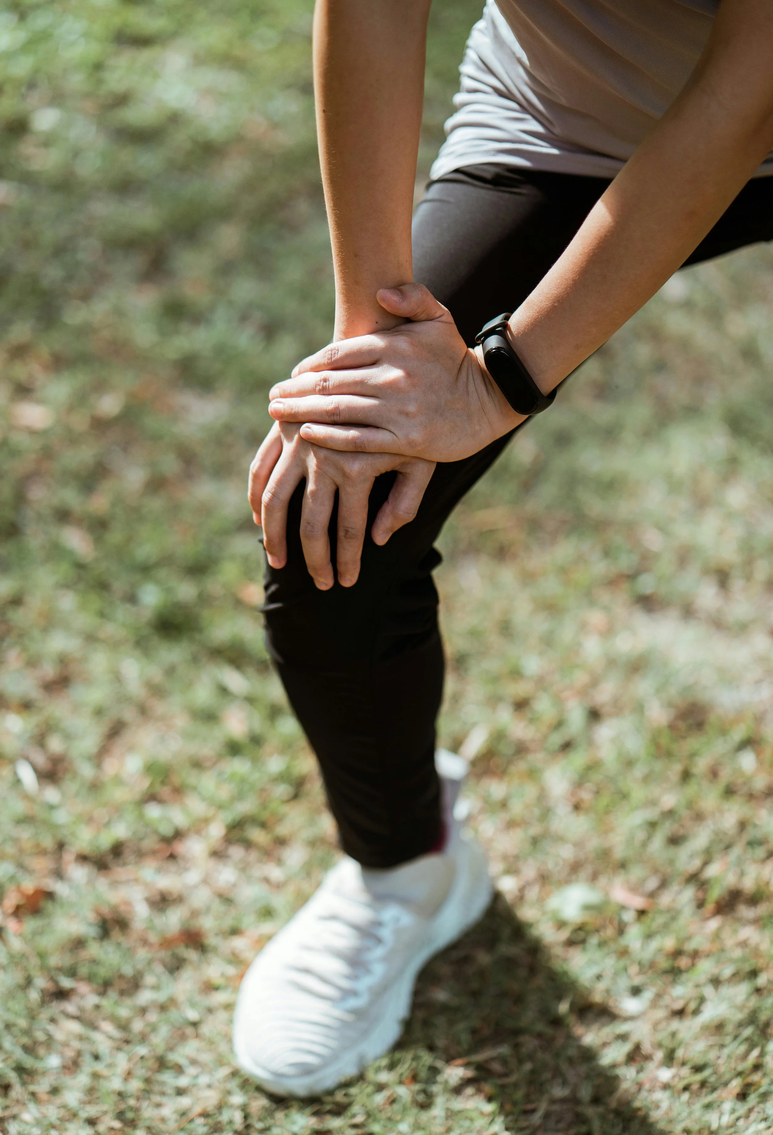 Athlete stretching their knee.