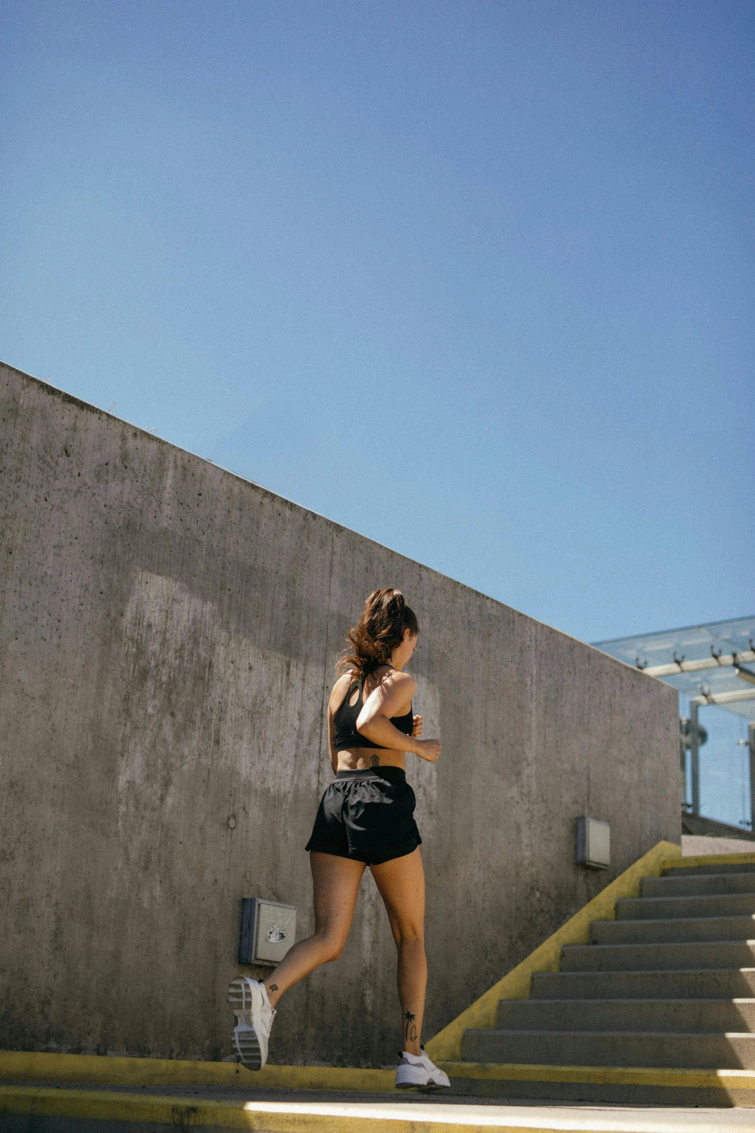 woman training by running up stairs