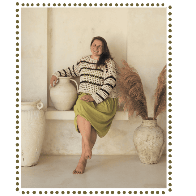 ann, perfectionism therapist at everbe therpy sitting on a classic stone benc