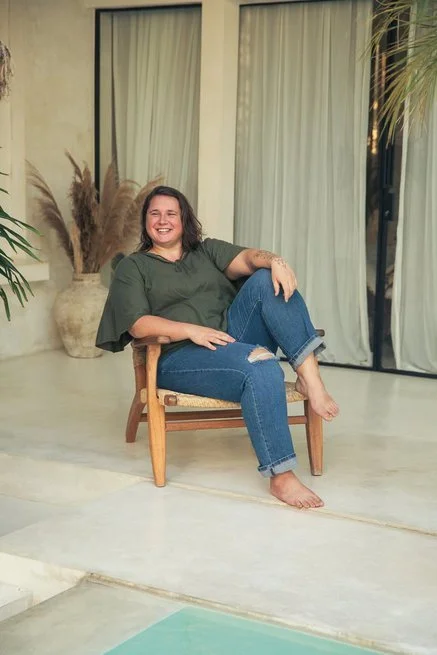 dr. ann krajewski sitting in a chair smiling at the camera after working with her codependency counseling clients
