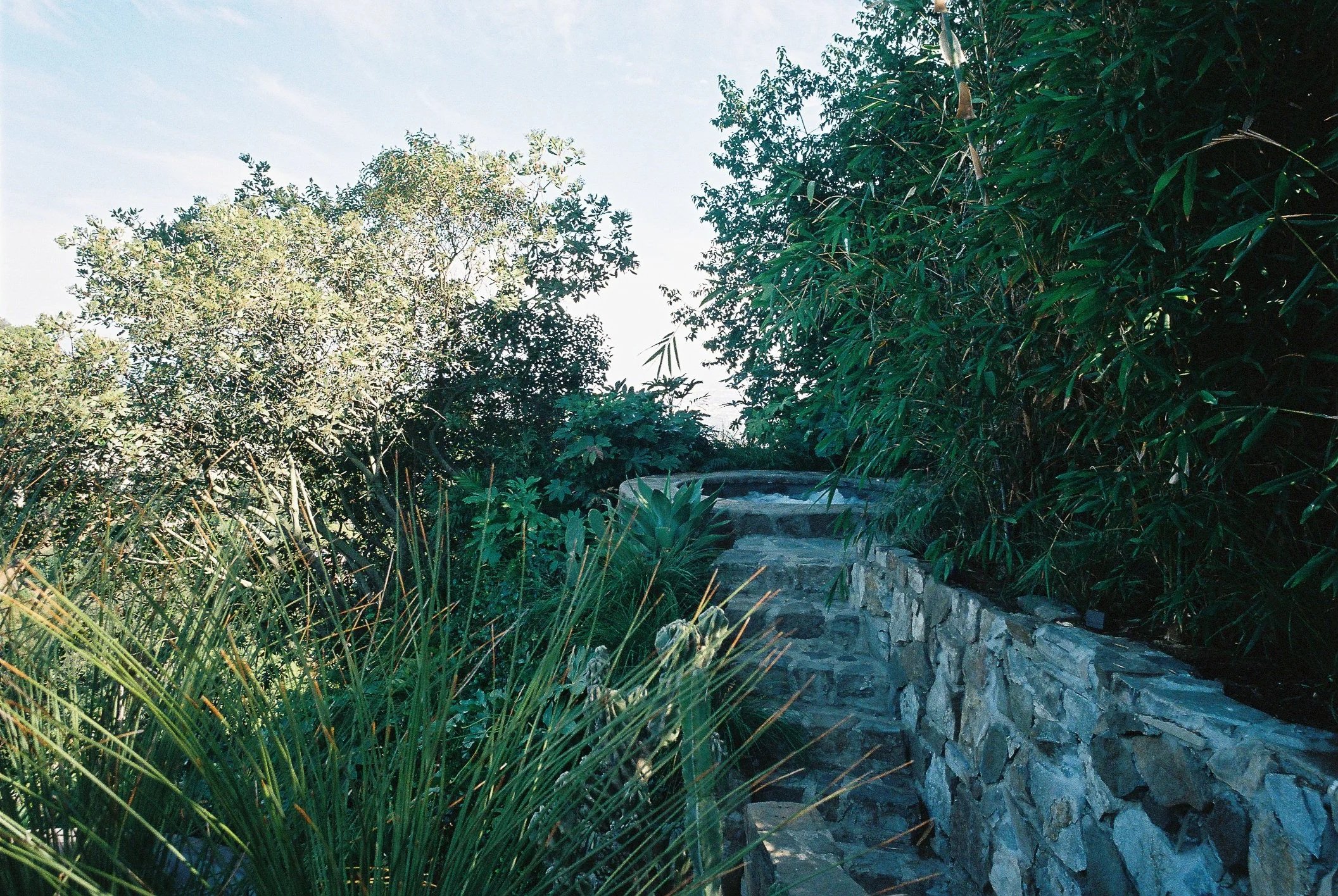Stone pathway leading to the spa and Hollywood Hills view at Bill Kaulitz's house designed by Frank Lloyd Wright Jr. restored by Michel Architects and featured on the cover of Architectural Digest