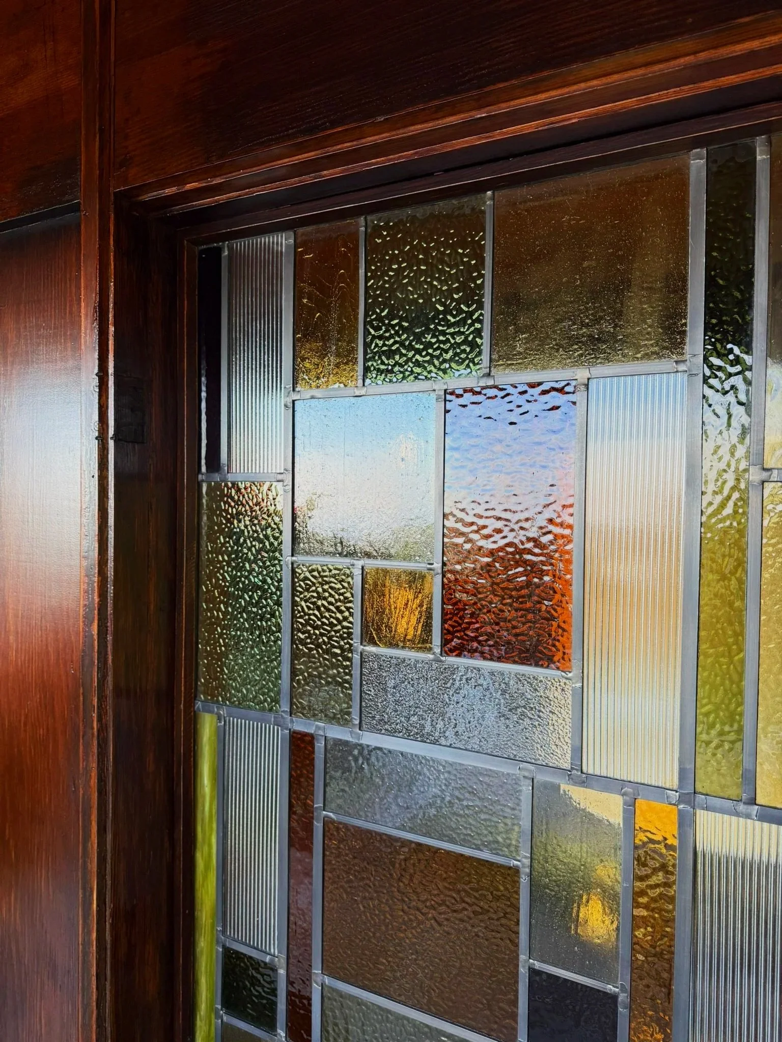 Detailed image of the new stained glass design at the Lloyd Wright Jr. original the De Jonghe Residence, designed by Michel Architects
