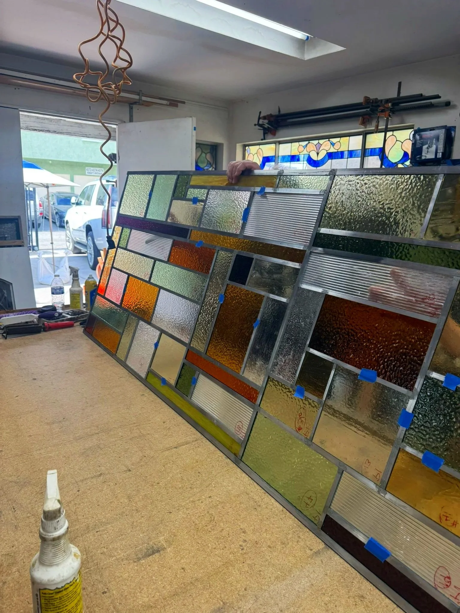 Stained glass window assembly in the shop for the De Jonghe Residence, designed by Michel Architects