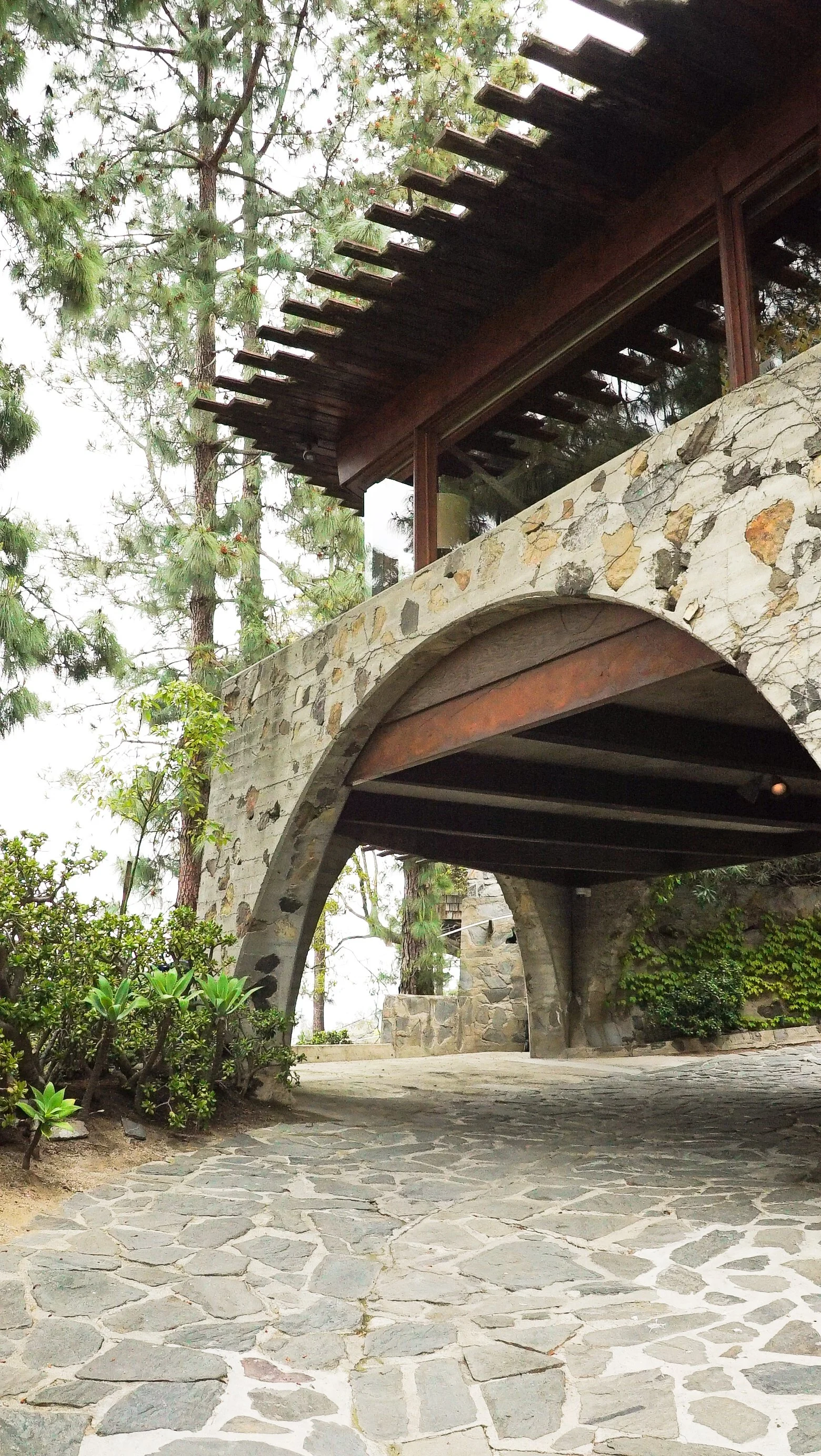 Driveway entrance and car port below the home of the De Jonghe Residence, an original by Lloyd Wright Jr. in Laurel Canyon, Los Angeles, restored by Michel Architects