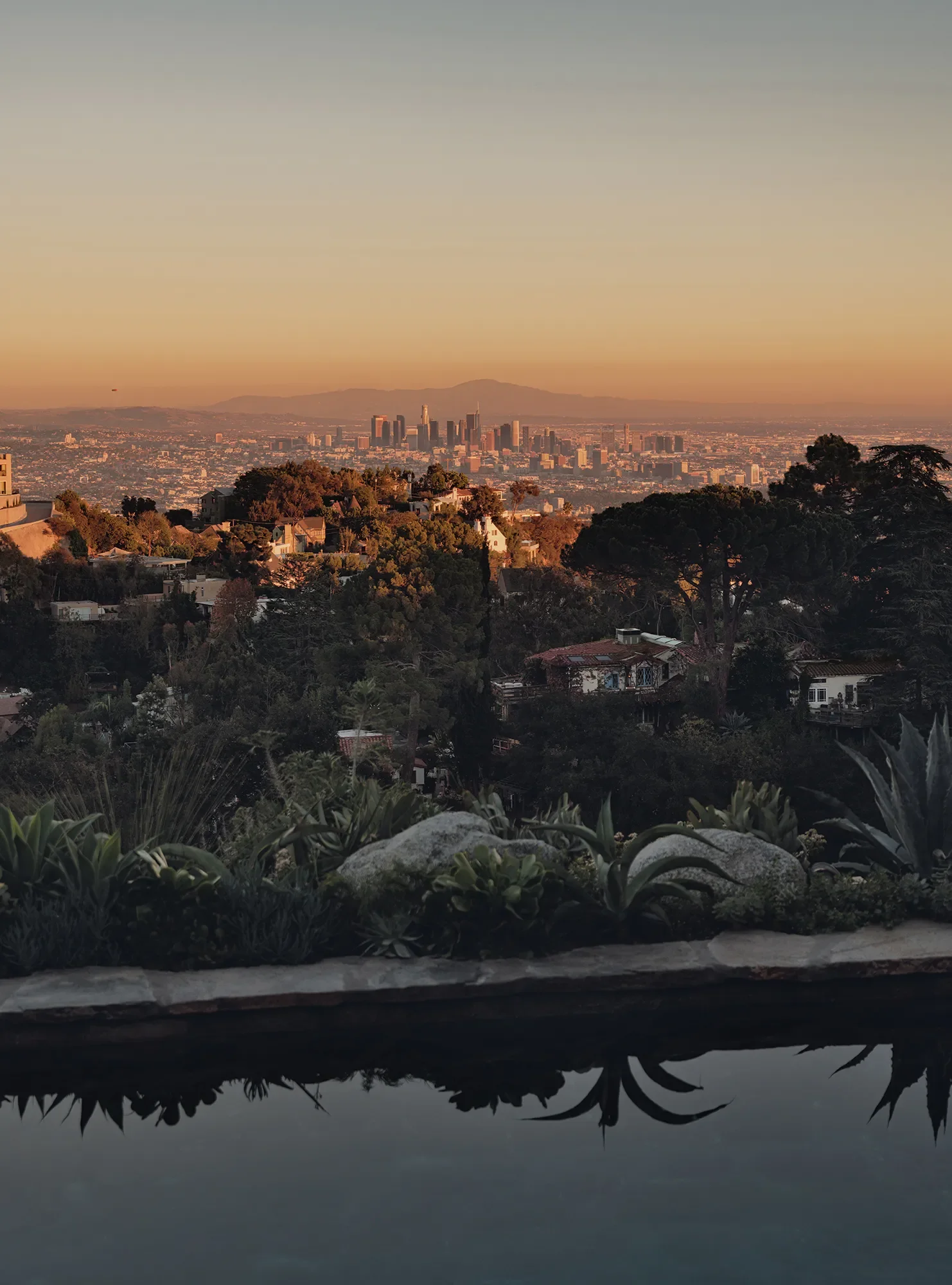 Sunset view of pool and Los Angeles Skyline atFrank Lloyd Wright Jr. De Jonghe Residence exterior, Laurel Canyon, Los Angeles — restored by Michel Architects