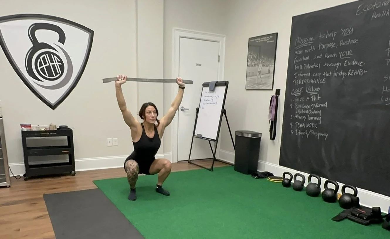 Overhead squat assessment at Ecotone Performance Health and Fitness to evaluate movement quality, mobility, stability, and functional movement patterns as part of the Ecotone Performance System in Saratoga Springs, NY.