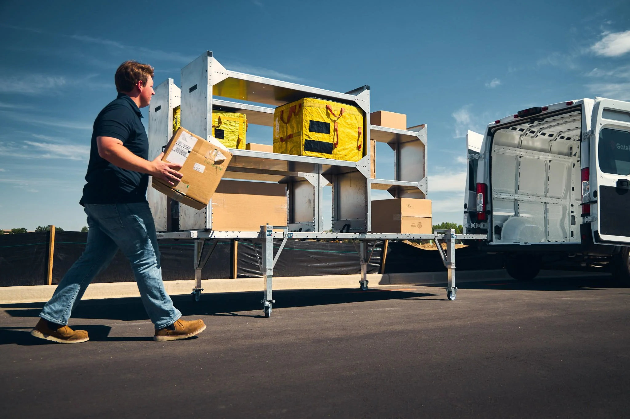 trades worker placing a box on metal shelving units