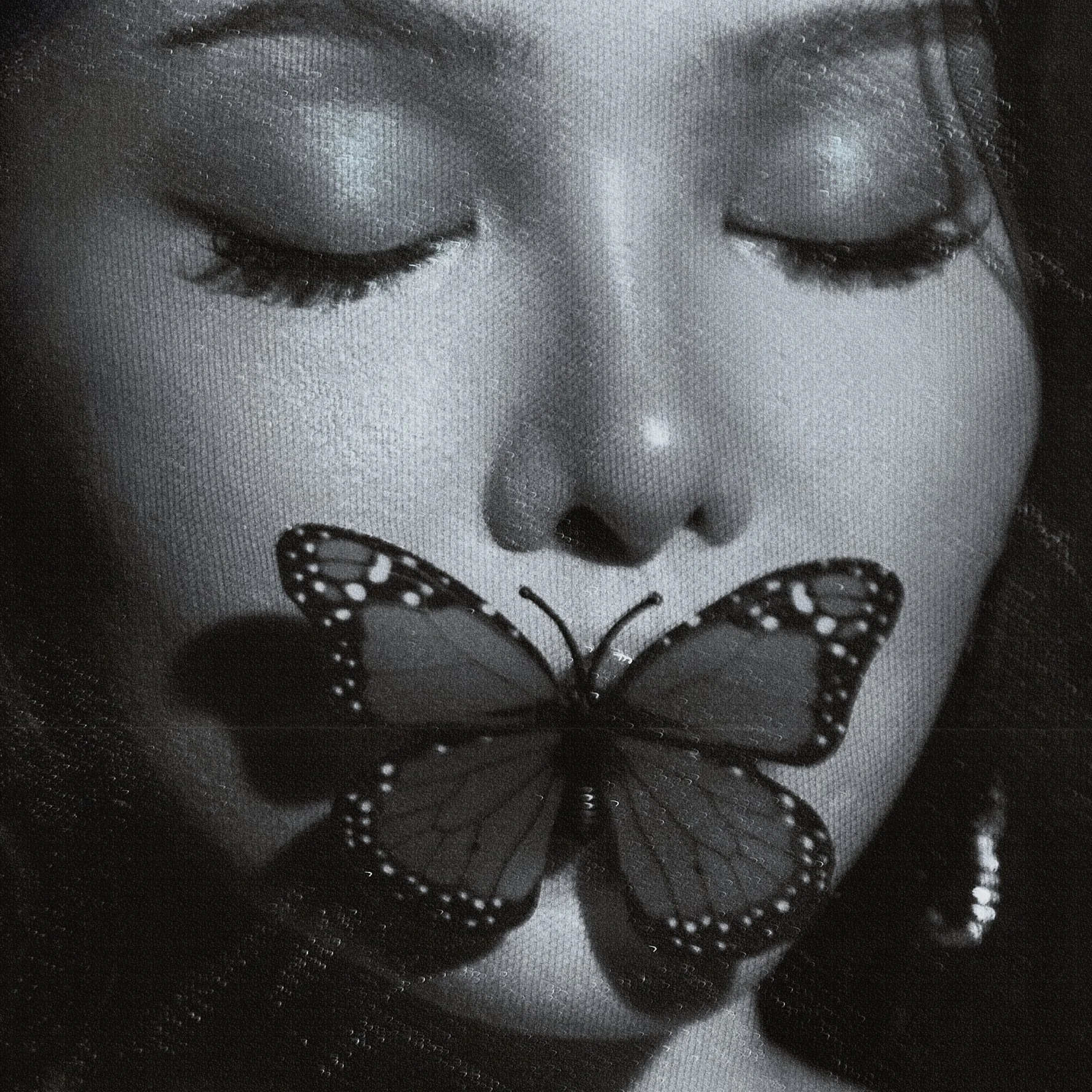 Close-up black and white photo of a person's face with closed eyes, and a butterfly resting on their lips.