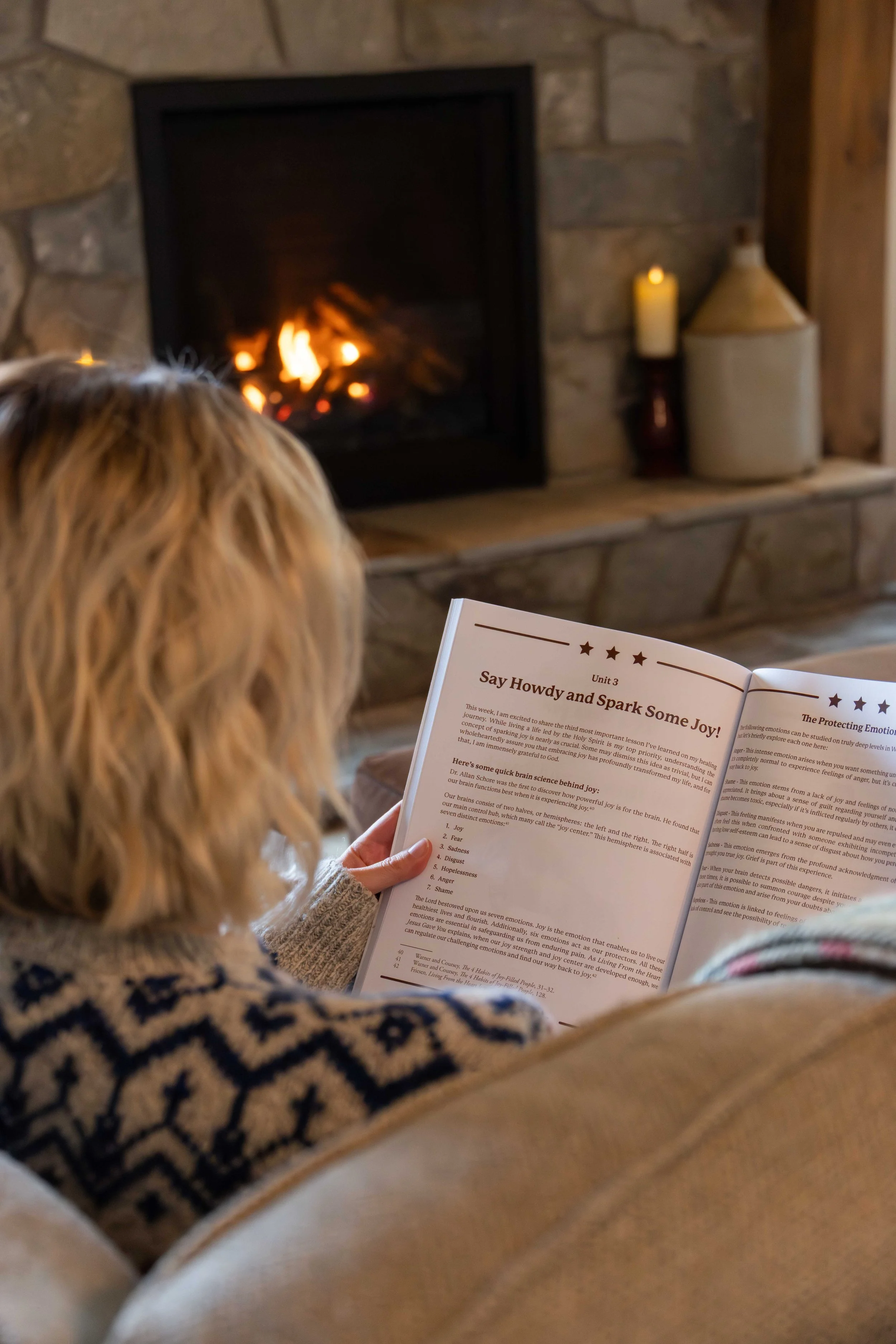 Picture of Melissa Prusinski reading book in front of fireplace