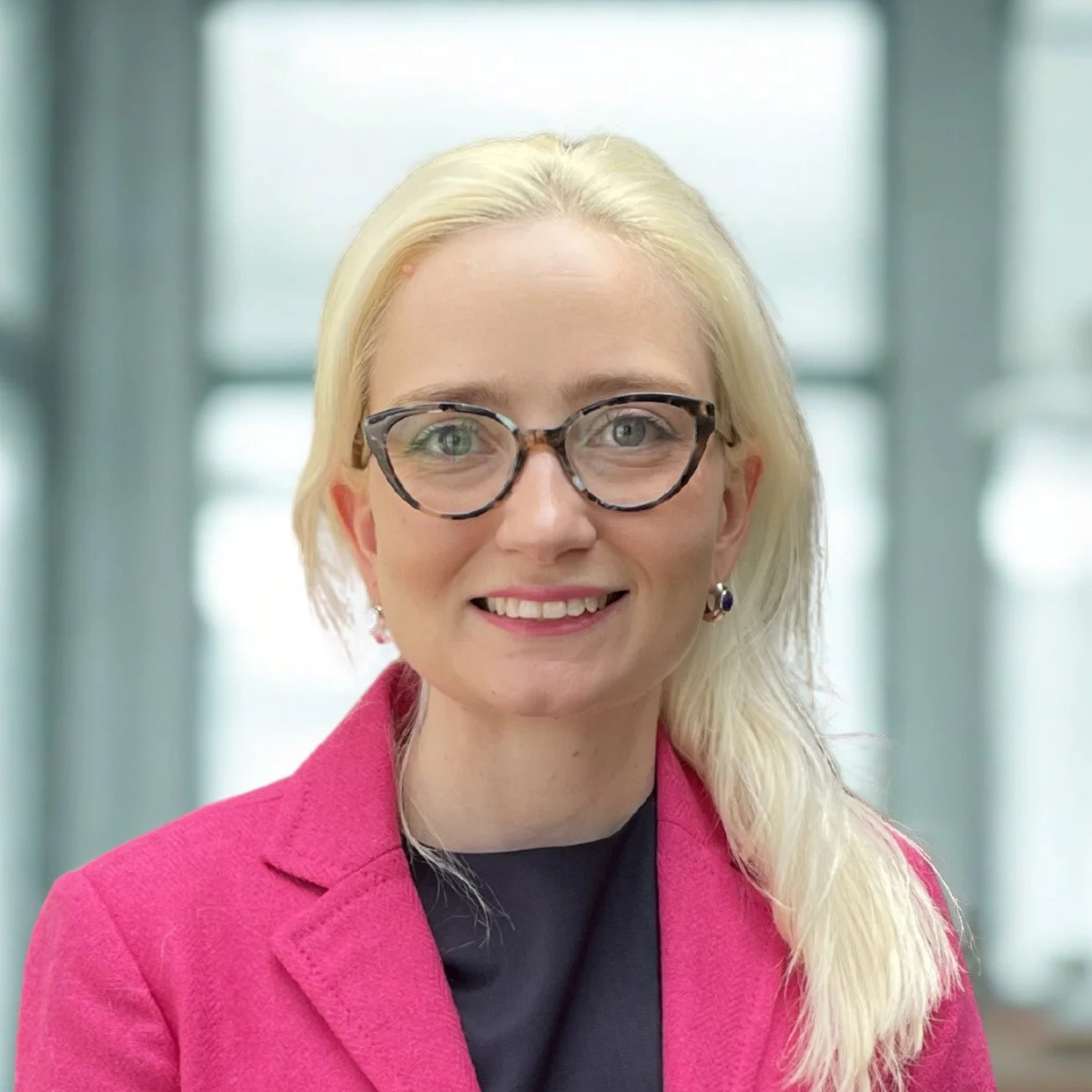 person with glasses smiling