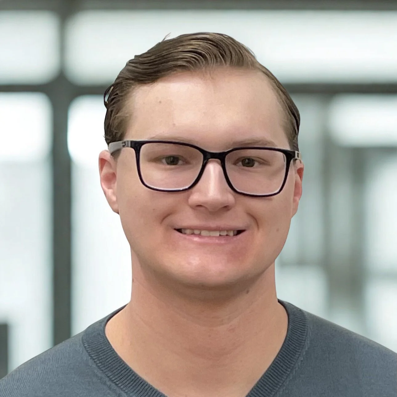 person with glasses smiling