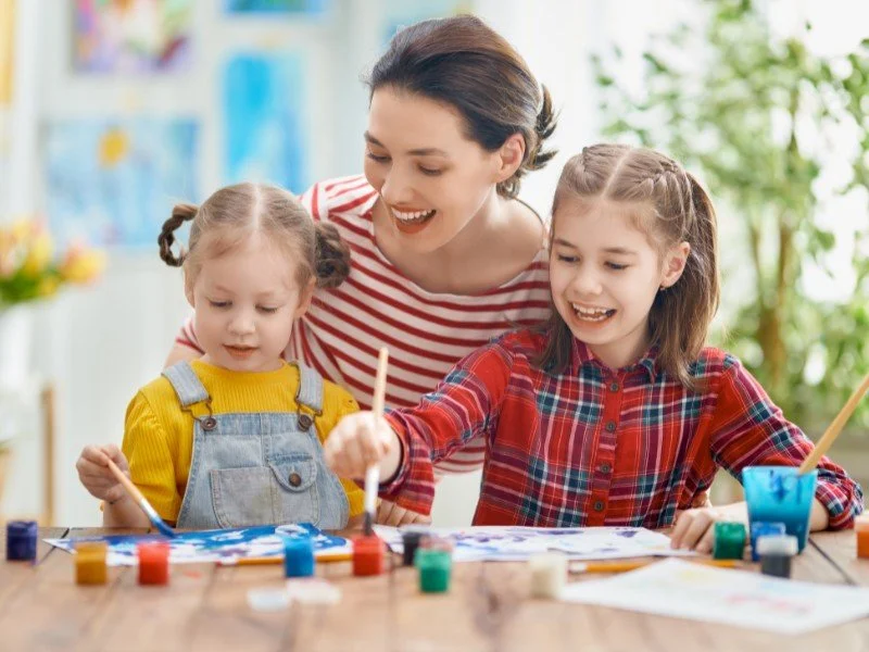 Mother Painting with Children at Decluttered Table