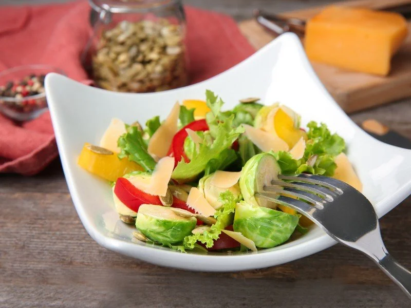 Preparing or enjoying a fresh salad.