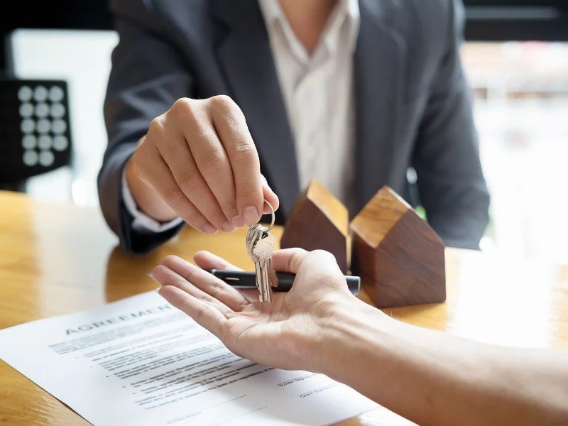Handing over house keys, contract signing.