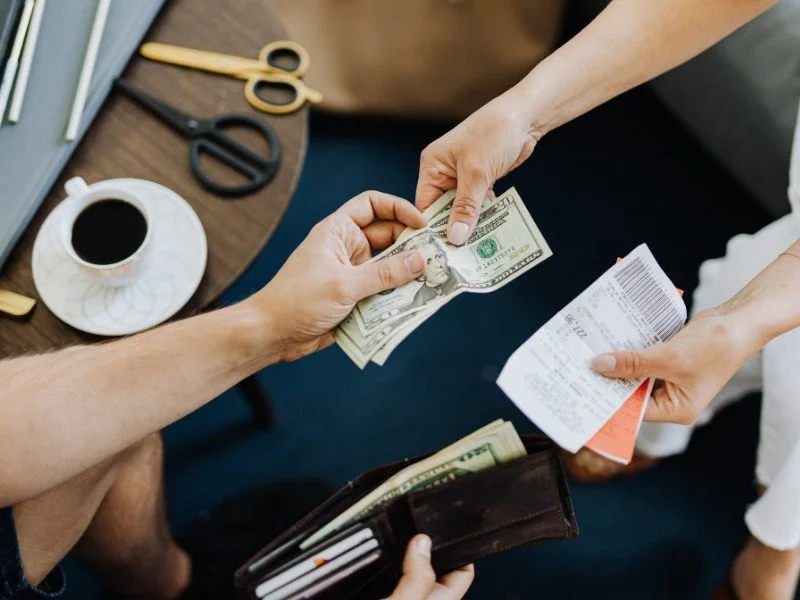 Handing over cash and receipts.