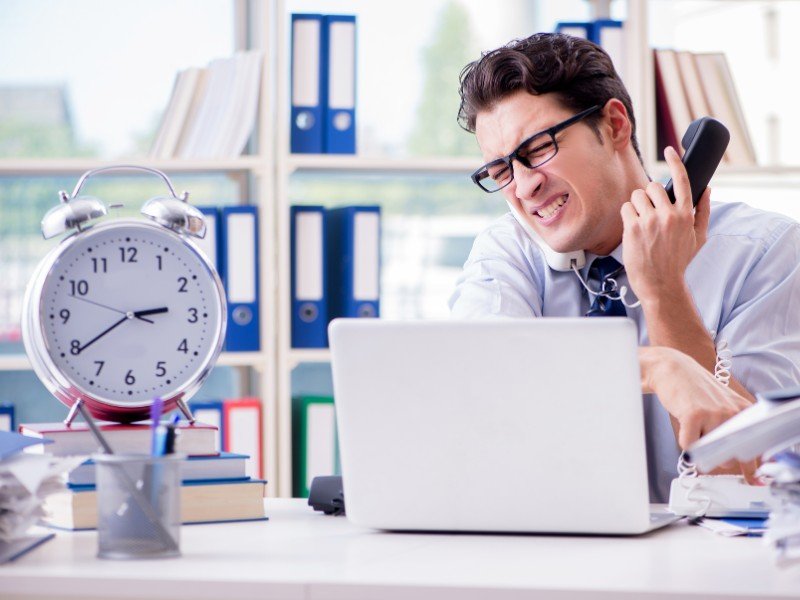Stressed businessman under time pressure.