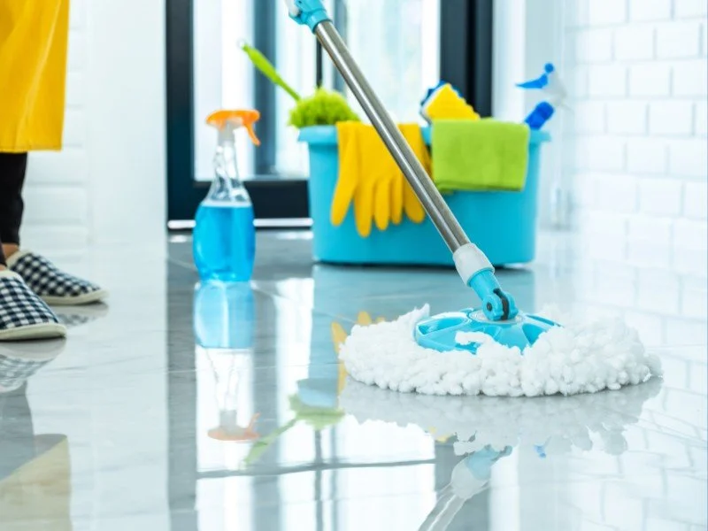 Mopping floors with cleaning essentials.
