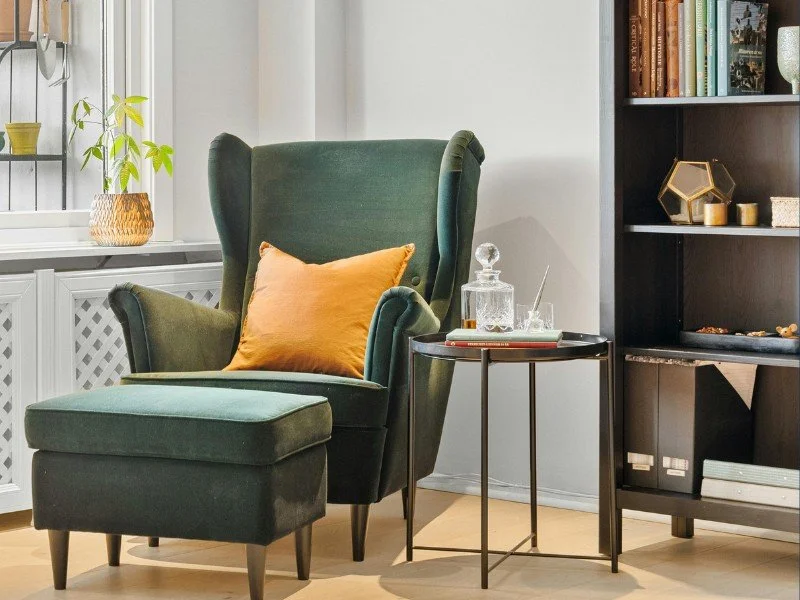 Cozy reading nook with green chair.