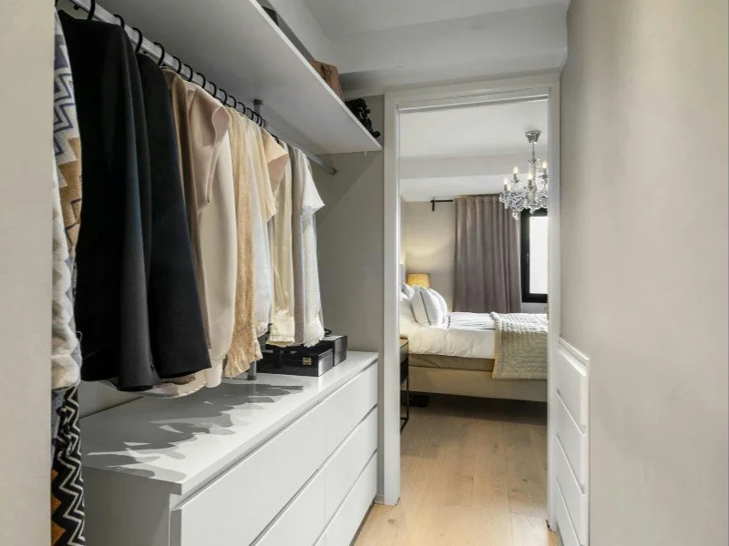 Neatly organized walk-in wardrobe space.