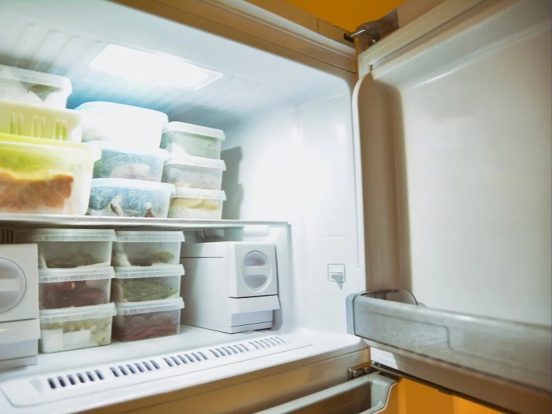 Organized freezer filled with labeled containers.