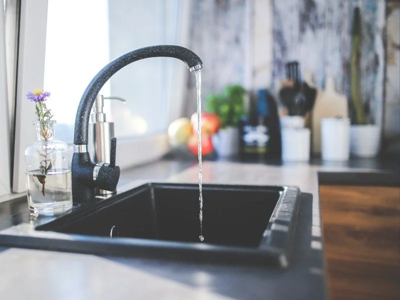 Running water from a kitchen faucet.