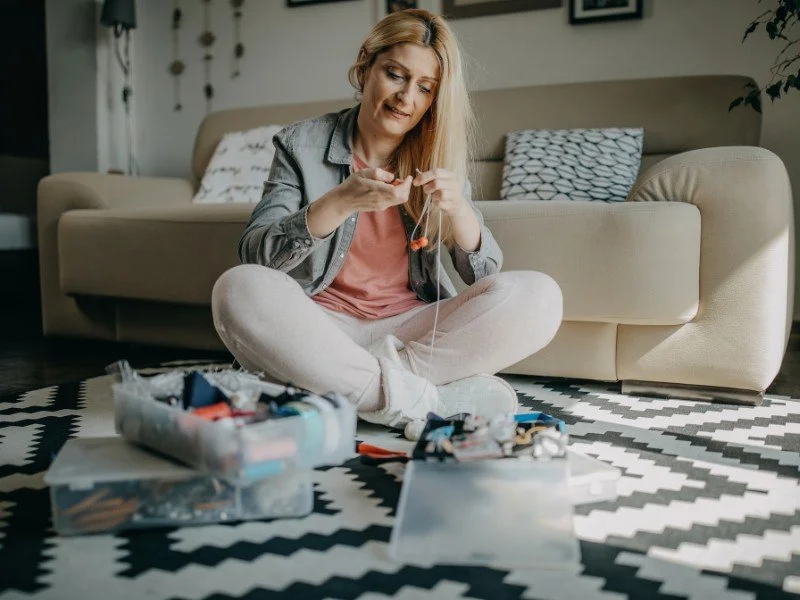Woman crafting and organizing at home.