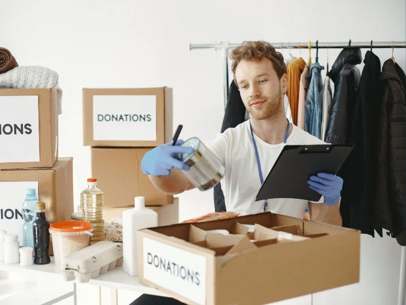 Volunteer sorting donation boxes.