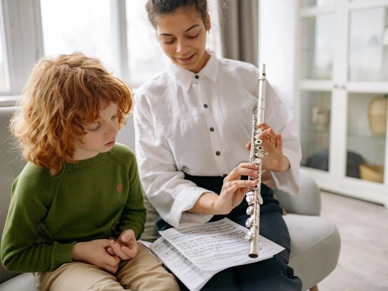 Teaching music to a young student.