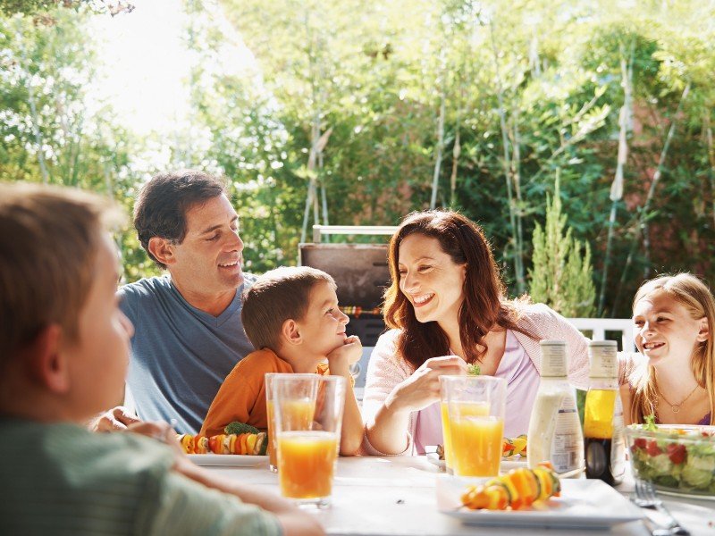 Family enjoying a meal outdoors.