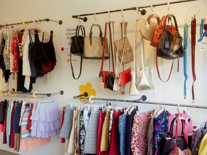 Colorful clothing and accessories in a store.