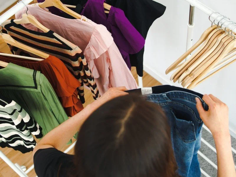 Sorting clothes for wardrobe arrangement.